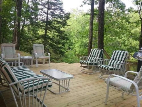 a group of chairs and a table on a deck at Timber Bend Retreat in Evart