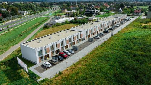 an overhead view of a large building with cars parked outside at Vip Apartamenty in Rzeszów