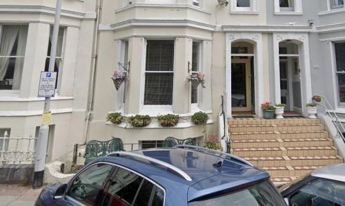 a blue car parked in front of a house at Townhouse II in Plymouth