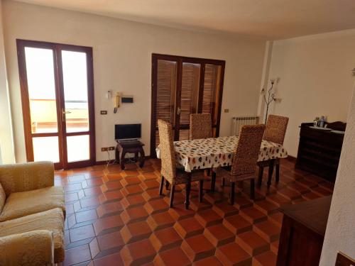 a living room with a table and chairs and a couch at Frontemare in Porto Santo Stefano
