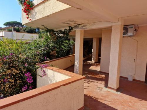 an outside view of a house with flowers and plants at Frontemare in Porto Santo Stefano