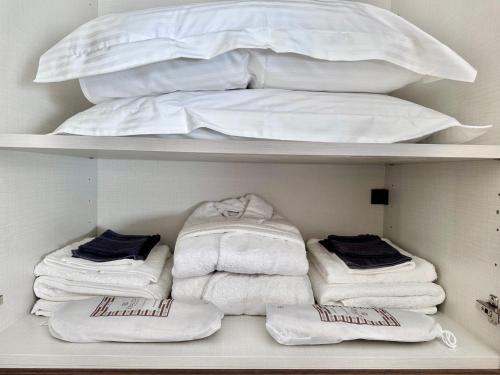 a closet with white towels and a bed at Topos luxury stay Heraion in Loutraki