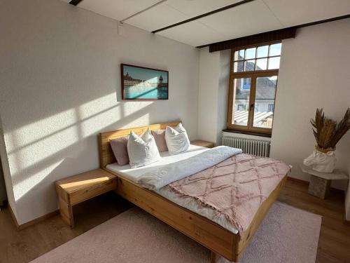 a bedroom with a bed in a room with a window at Schönes Apartment in Schöftland in Schöftland