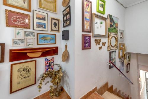 a hallway with a bunch of pictures on the wall at Apartamento Valencia in Catarroja