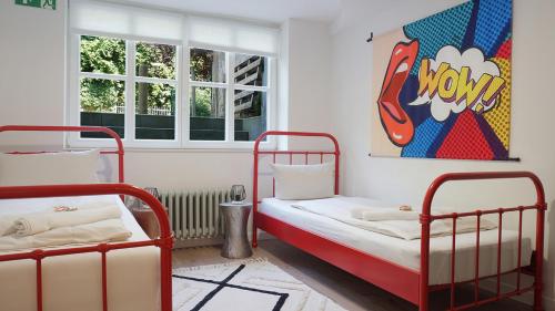 a room with two beds and a window at Heger Tor Apartments in Osnabrück