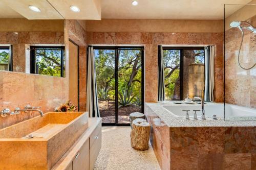 a large bathroom with a tub and a sink at The Haven by Lodgewell - Where serenity meets sanctuary in Austin