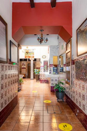 a hallway of a restaurant with a red ceiling at Hotel el Carmen, Morelia in Morelia