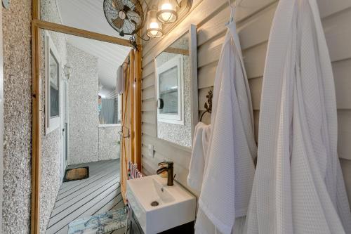 a bathroom with a sink and a mirror at Coastal St Simons Retreat Near Gascoigne Bluff! in Saint Simon Mills