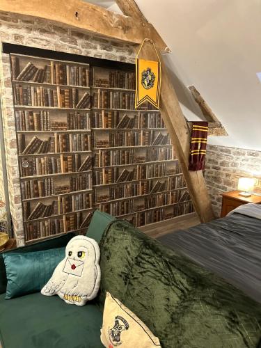 a room with a couch with a stuffed ghost on it at Le Terrier du sorcier in Floyon