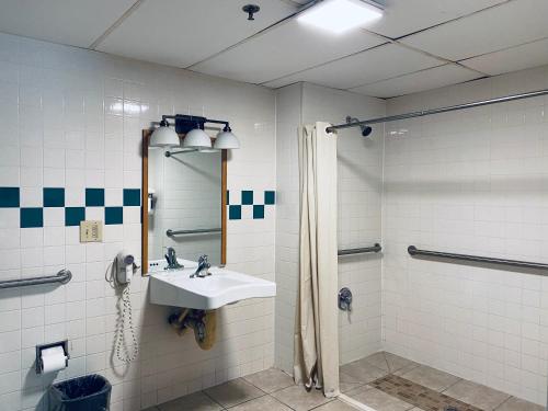 a bathroom with a sink and a shower at Excel Inn & Suites in Fredericksburg
