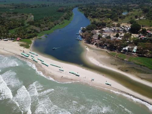 an aerial view of a beach with a group of people at HOSTAL CASA ALFON BURITACA in Santa Marta