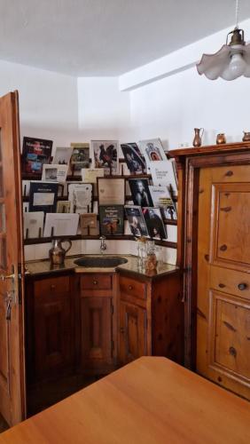a kitchen with a sink and a wall of photos at Weisses Kreuz - Crusch Alva in Samedan