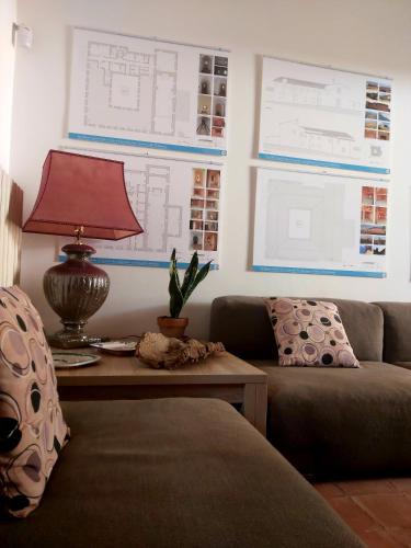 a living room with a couch and a table with a lamp at Al Convento in San Mauro Castelverde