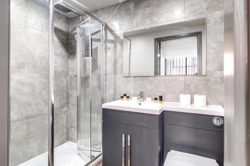 a bathroom with a sink and a shower at Luxe NY Loft-Style - Central Birmingham - 2BR - Lush Green Oasis in Birmingham