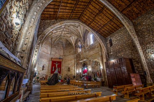 a large church with wooden pews in a building at AT la abuela Antonia- Ca Pablo in Torre de Don Miguel