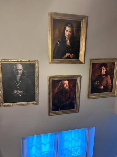 a wall with four pictures of people on it at Le Terrier du sorcier in Floyon