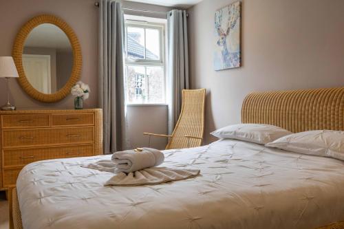 a bedroom with a bed and a mirror and a dresser at Regent House in Thirsk