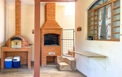 a brick oven sitting inside of a building at Otima casa de campo com churrasq em Sorocaba SP in Sorocaba