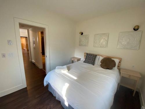 a bedroom with a white bed with a teddy bear on it at Brand New 1 Br 1 Bath Close To All Walkable in Edmonton