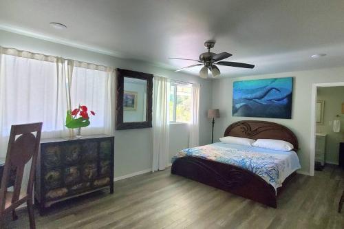 a bedroom with a bed and a ceiling fan at Private House Located between Volcano and Hilo in Mountain View