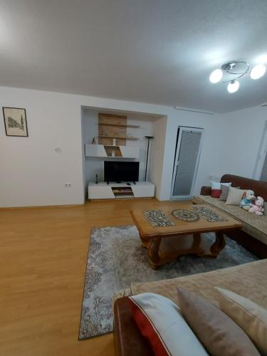 a living room with a couch and a coffee table at Apartman Riki in Sarajevo