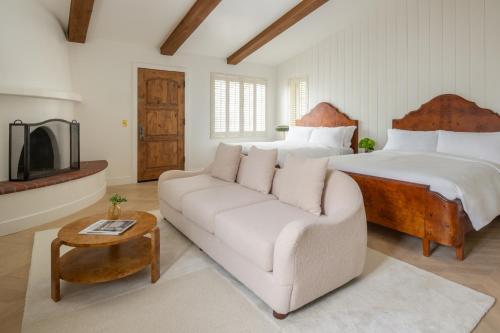 a living room with a couch and a bed at The Inn at Rancho Santa Fe in Rancho Santa Fe