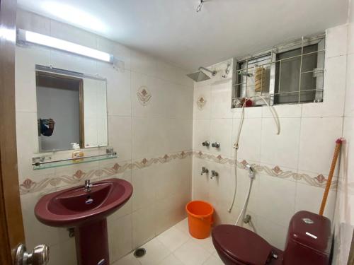 a bathroom with a red sink and a shower at Cozy Ac Private bedroom Gulshan 1 - 6km Airport in Dhaka