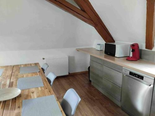 a kitchen with a table and a counter with chairs at David in Fellering