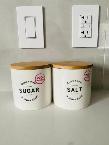 two containers of sugar sitting next to a light switch at Richmond Sweet home in Richmond