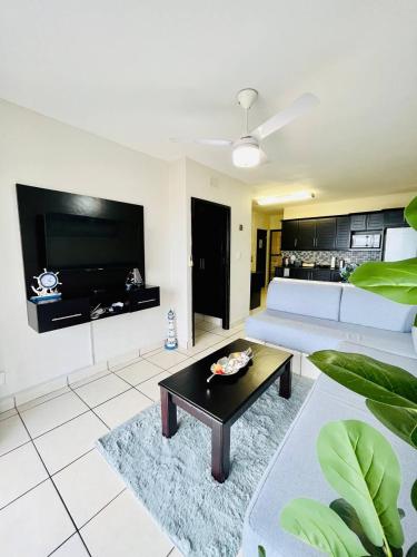 a living room with a couch and a table at Illovo Beach View in Kingsborough