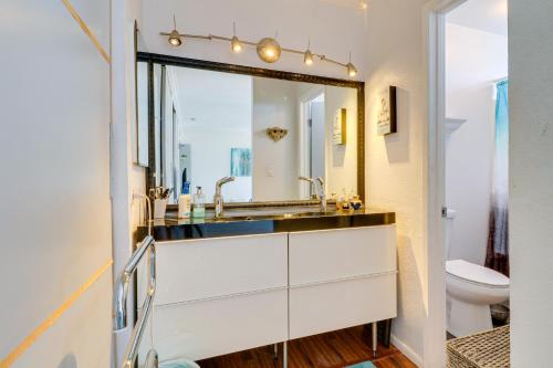 a bathroom with a sink and a mirror at Granada Hills Condo with Community Pool and Desk! in Los Angeles