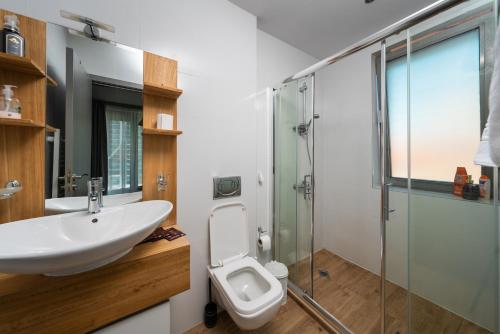 a bathroom with a sink and a toilet and a shower at Vertigo Huge Apartment 2 Bedrooms Balcony Parking in Sofia