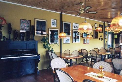 a restaurant with tables and chairs and a piano at Agriturismo Il Mio Casale in Monte Colombo