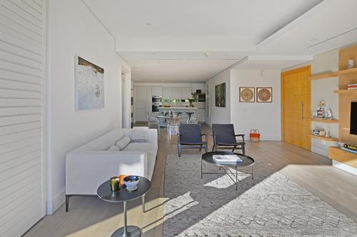 a living room with a couch and two tables at Marina 107 in Cape Town