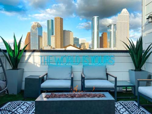 a group of chairs sitting on a balcony with a city skyline at Urban Jungle Retreat in the HTX Skyline in Houston
