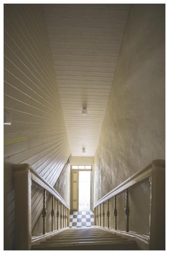 a hallway with a door and stairs in a building at Hapsal Dietrich apartemendid in Haapsalu