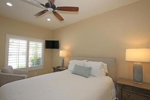 a bedroom with a white bed and a ceiling fan at DL831 - Desert Falls Circle in Palm Desert