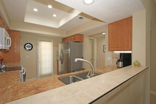 a kitchen with a sink and a refrigerator at DL831 - Desert Falls Circle in Palm Desert