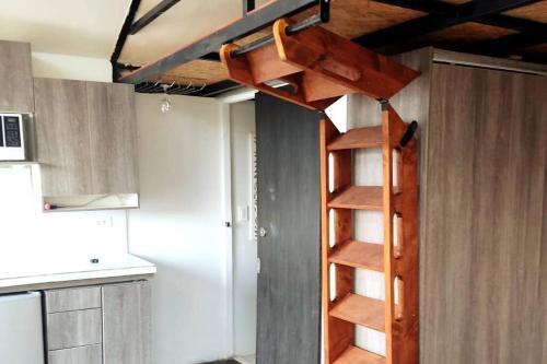 a loft bed in a kitchen with a spiral staircase at WICHI LAGO in San Pablo