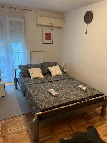 a bedroom with a bed with two pillows on it at Apartman West - private parking place in Zagreb