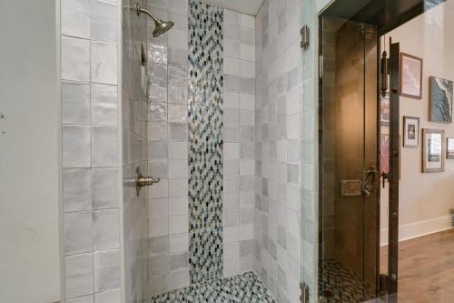 a walk in shower with a shower seat in a bathroom at Upscale Texarkana Townhome, Walk to Downtown! in Texarkana