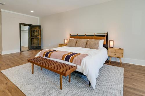 a bedroom with a large bed and a coffee table at Upscale Texarkana Townhome, Walk to Downtown! in Texarkana