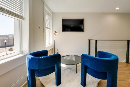 a living room with two blue chairs and a table at Upscale Texarkana Townhome, Walk to Downtown! in Texarkana