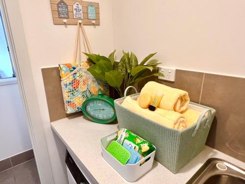 a kitchen counter with a sink and a clock at Seaside Sanctuary Port Noarlunga in Port Noarlunga South