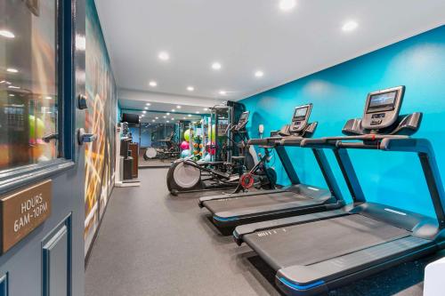a gym with three treadmill machines in a room at Best Western Plus Westbank in Harvey