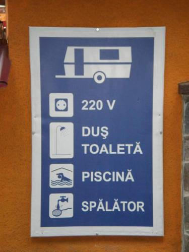 a blue sign on the side of a building at Complex Turistic Caprioara in Baia Mare