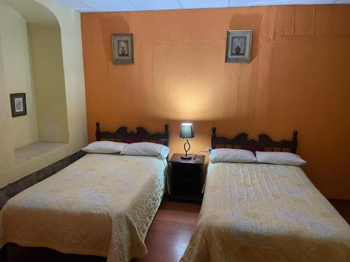 two beds sitting next to each other in a room at METROPOLITANO HOTEL in Riobamba