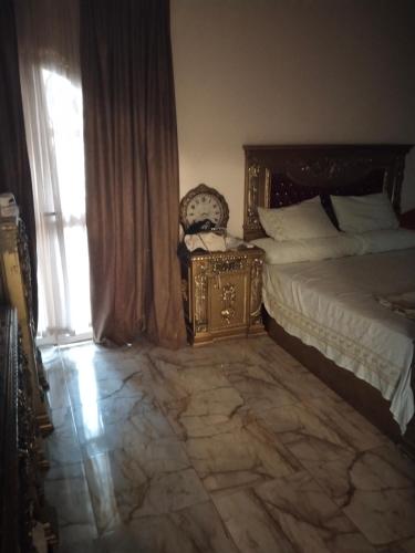 a bedroom with a large bed and a window at Giza view in Cairo