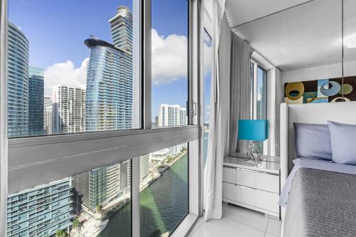 a bedroom with a window with a view of the city at Luxurious Condo at ICON with Views in Miami