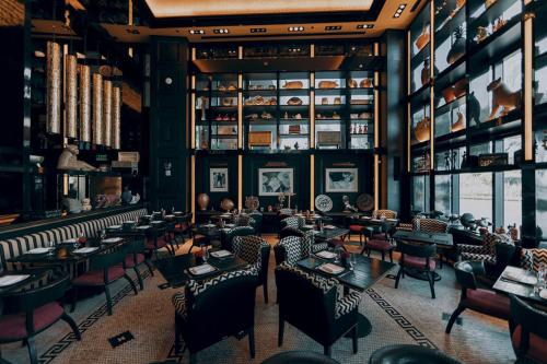 a restaurant with tables and chairs in a room at Luxurious Condo at ICON with Views in Miami